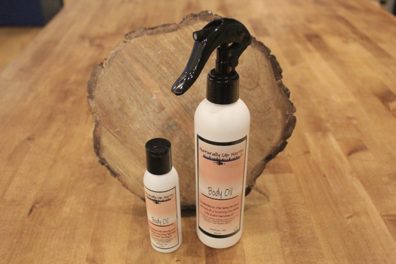 Two body oil bottles on wooden table